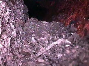 This image shows a fouled reactor screen. It was taken using an explosion-proof crawler and pan and tilt camera system.
